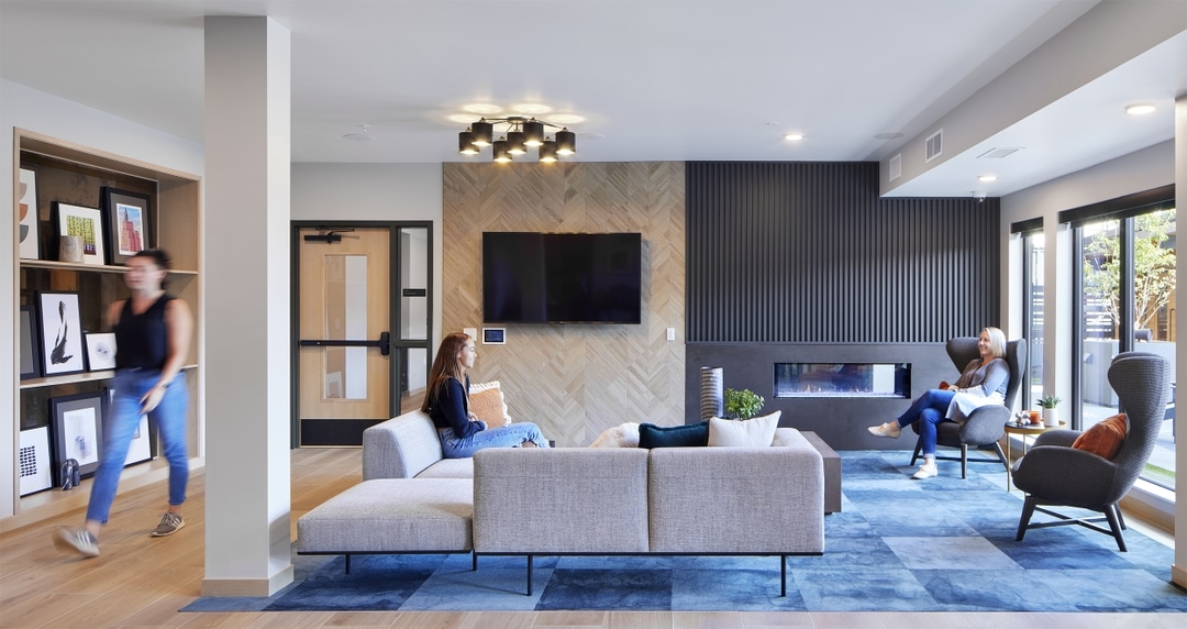 Second-floor clubroom at The Pitch with foosball table, kitchen and double-sided fireplace