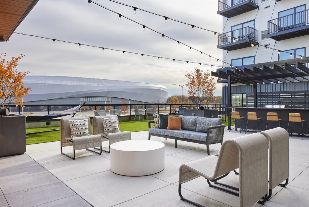 Elevated amenity deck at The Pitch with firepit, sauna, grill stations and dry bar